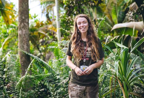 Horticulture student surrounded by plants in Eden's Rainforest Biome